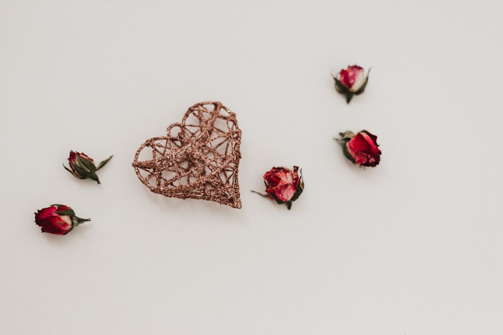 brown heart decor and five rose flowers