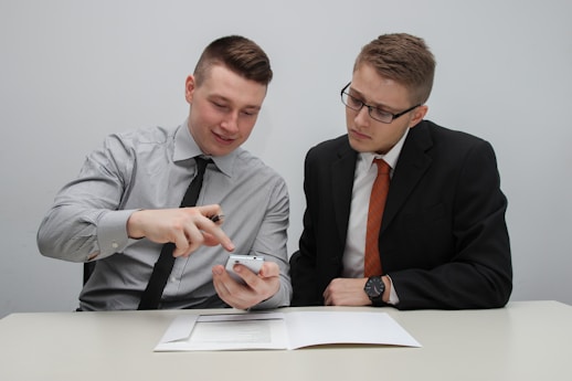two man watching smartphone