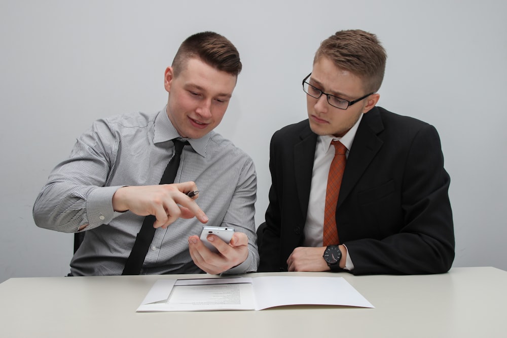 two man watching smartphone