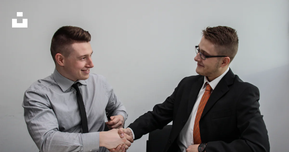 Businesspeople shaking hands in a professional office after reaching an agreement