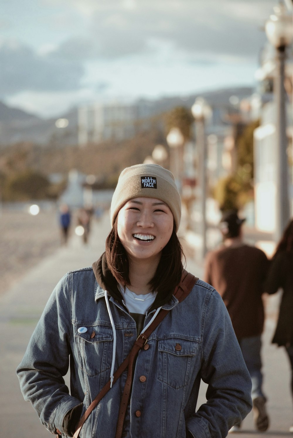 smiling woman wearing brown cap