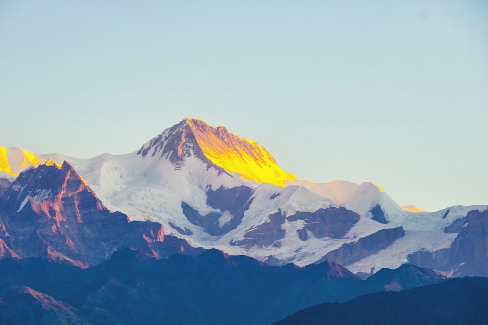 a snow covered mountain with a yellow light on it