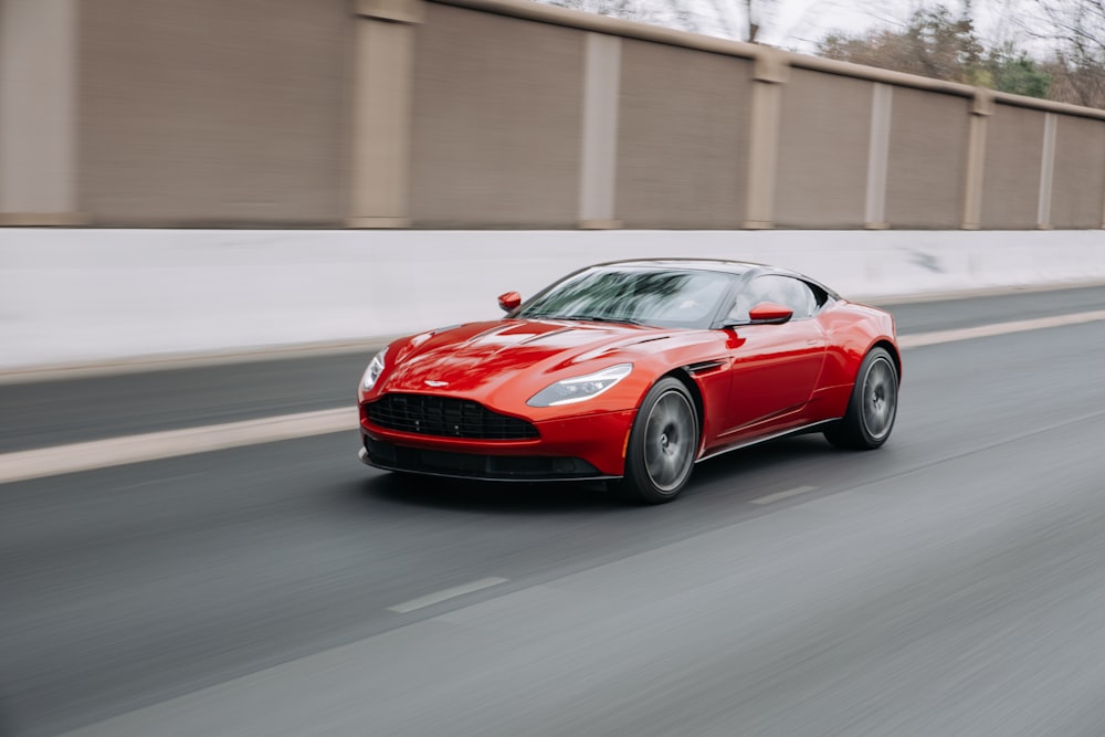 red coupe passing on road