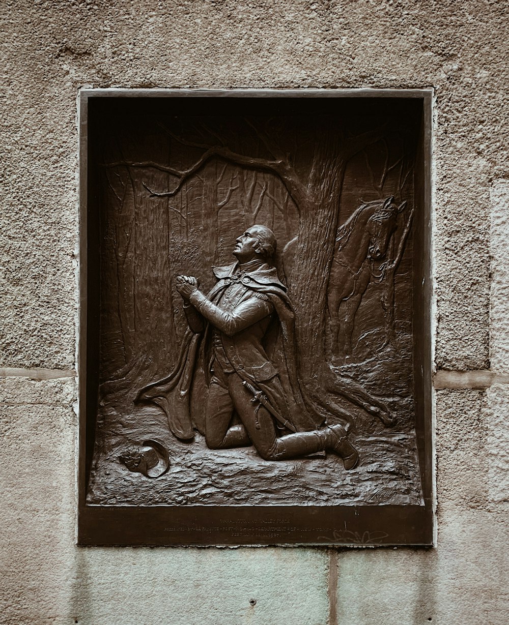 kneeling man embossed artwork