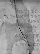 Before and after images showing restored faded inscriptions on a memorial stone.