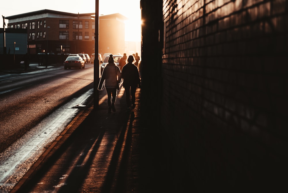 people walking near the street during golden hour