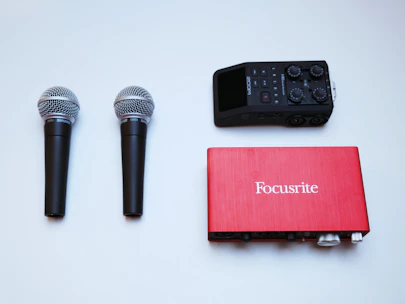 Close-up of a professional microphone and audio equipment arranged neatly on a table.