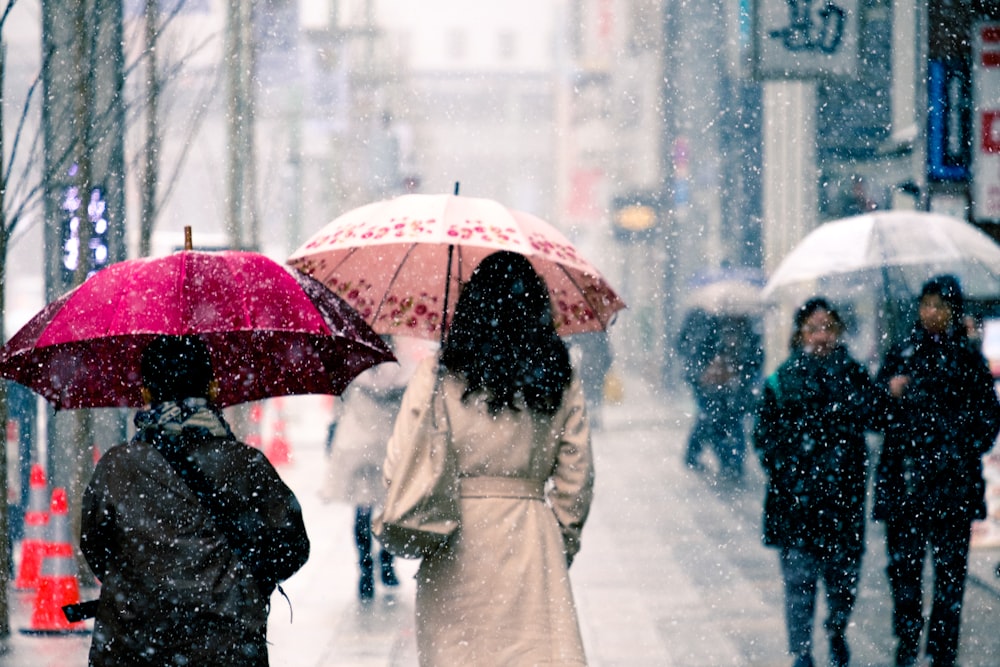 people walking on street under the rain