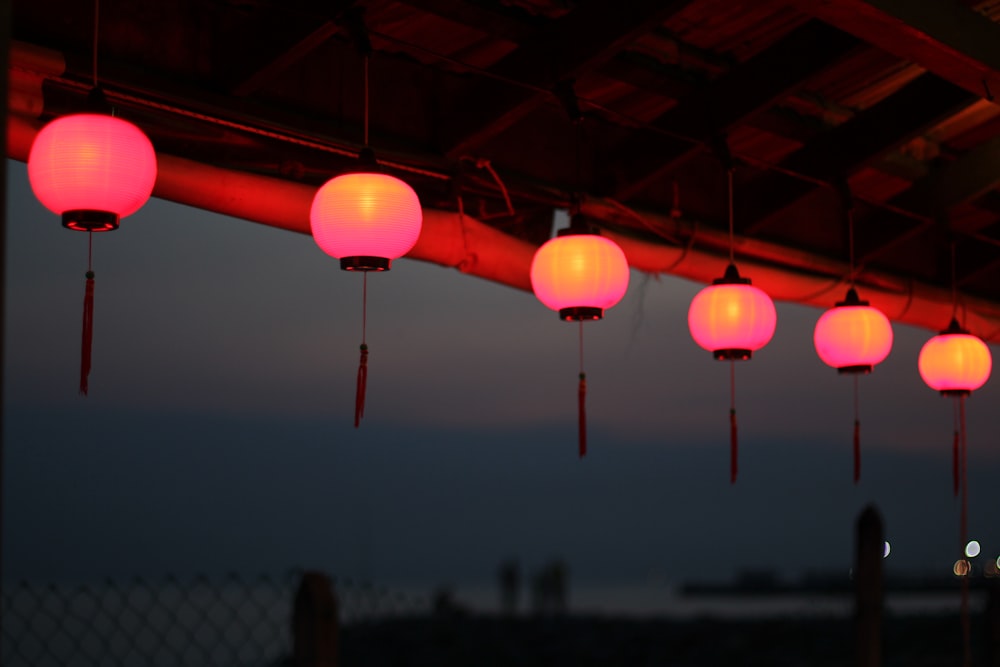 six pink pendant lamps turned-on