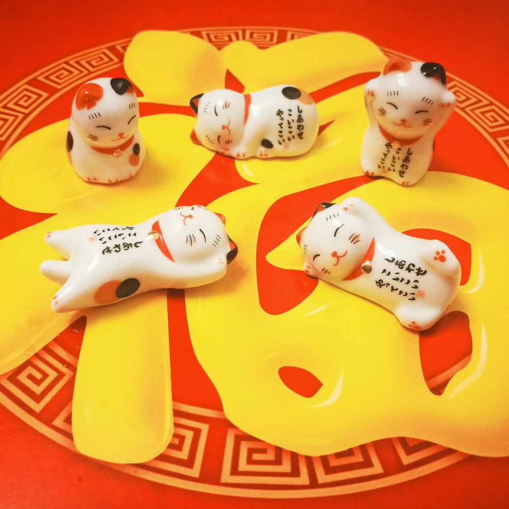 five ceramic cat figurines