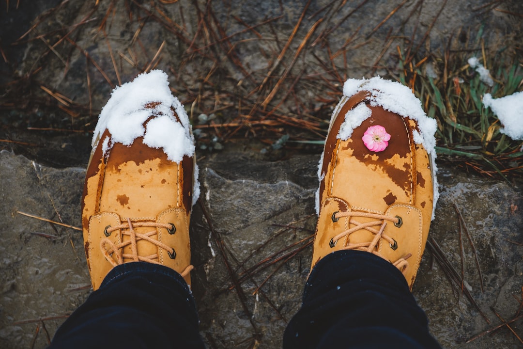 person's shoes with white snows