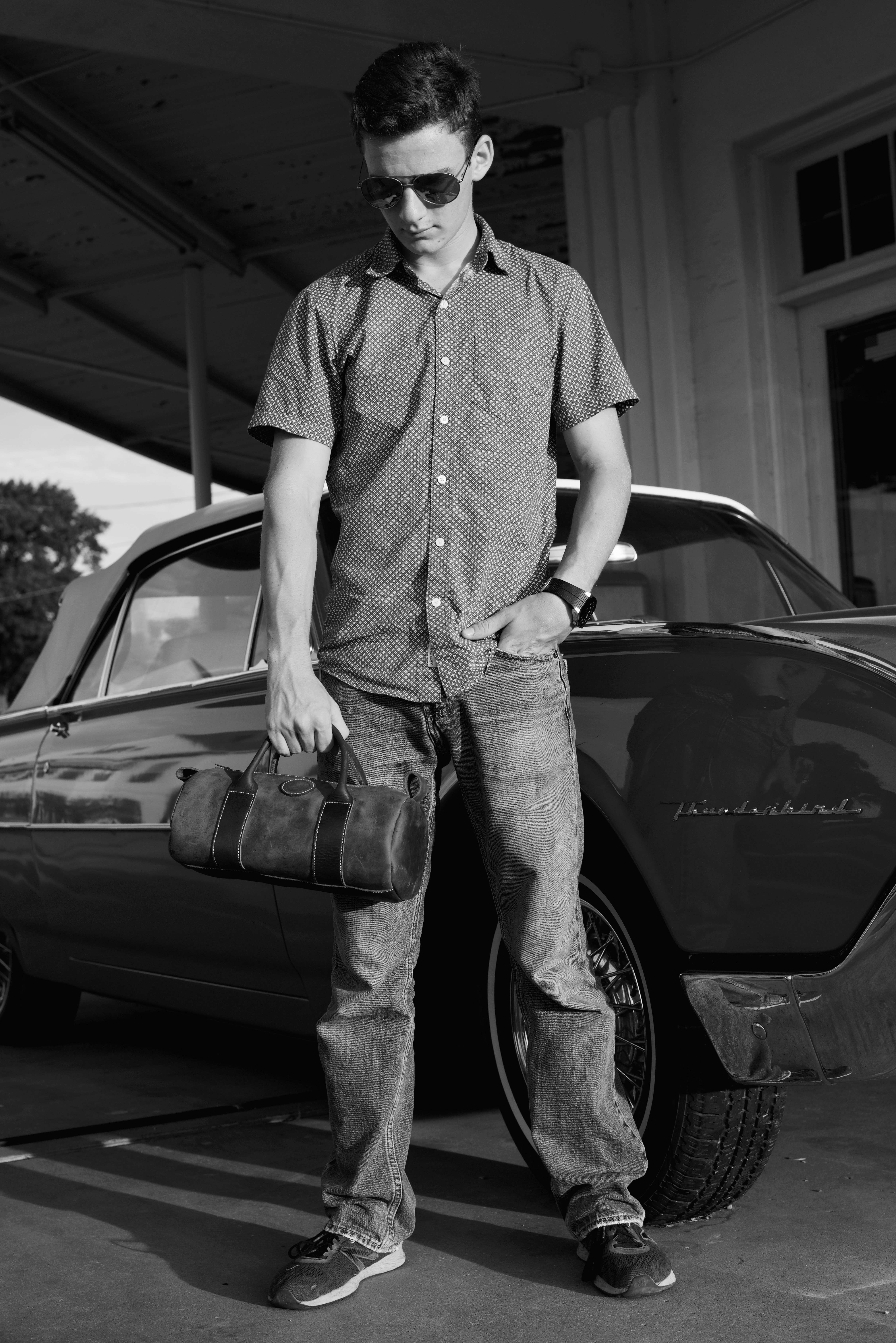man standing beside vehicle
