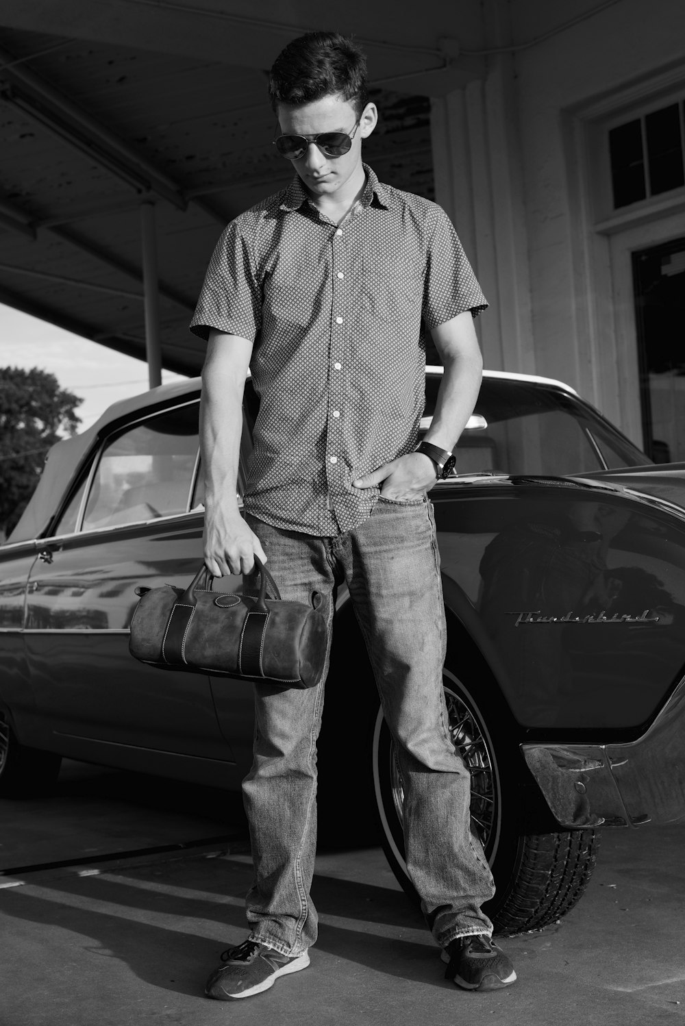 man standing beside vehicle