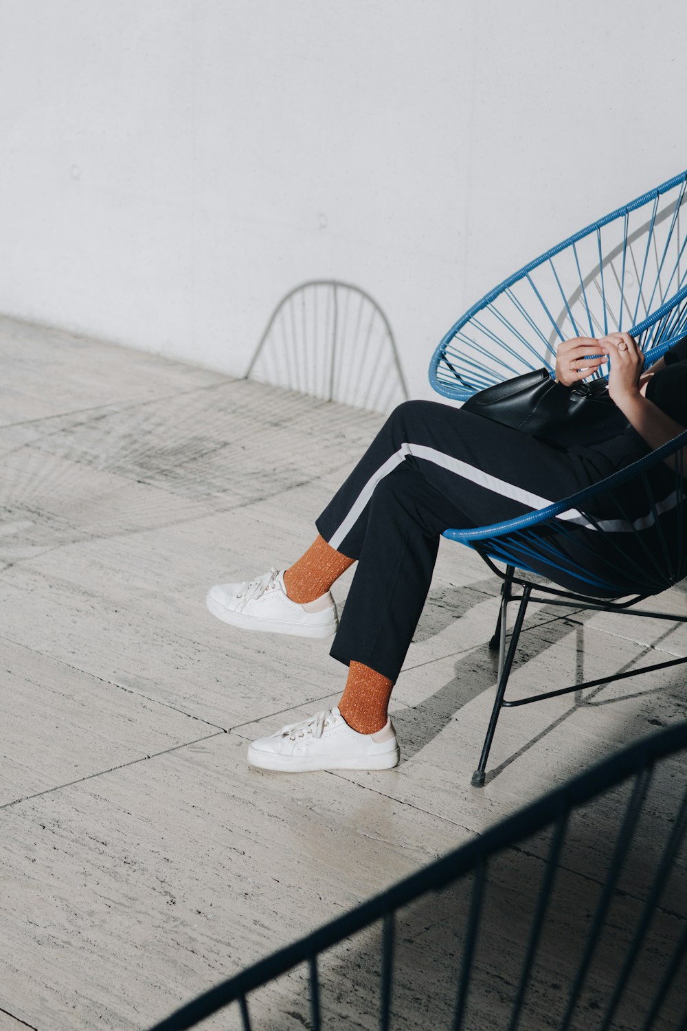 person in black pants sitting chair