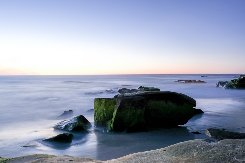 stone on body of water at daytime