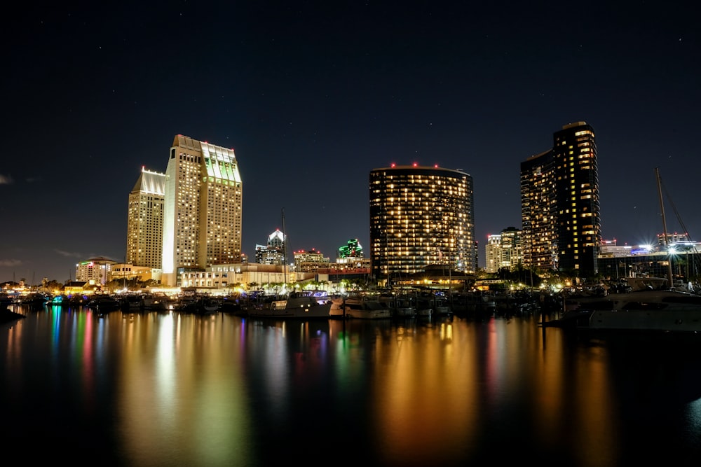 photograph of city high-rise buildings beside body of water