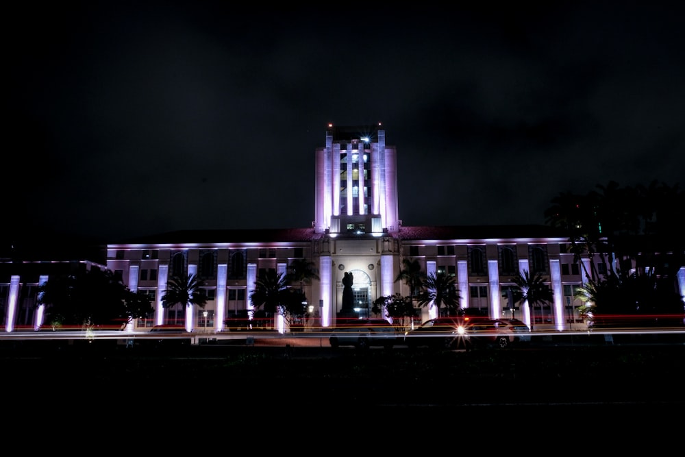 white concrete building with lights turned-on during nighttime