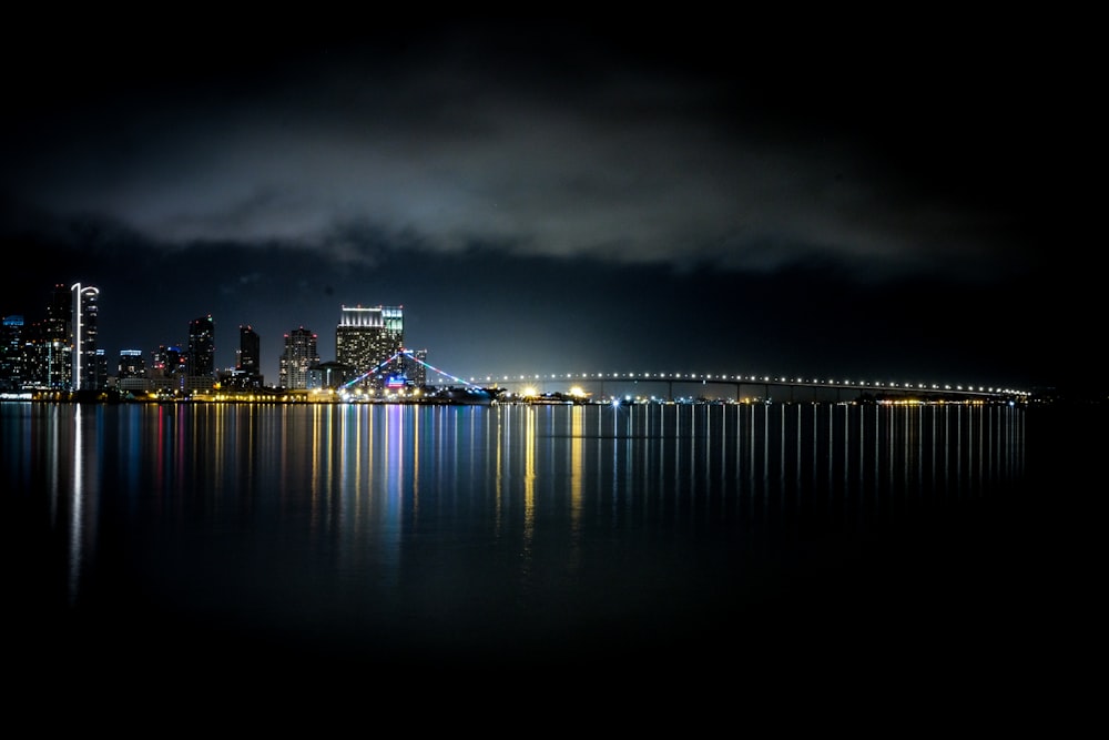 body of water across buildings at night