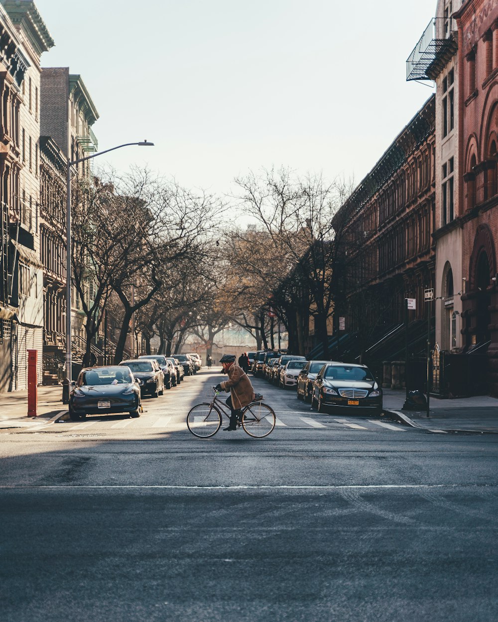 person riding bicycle at the middle of the street