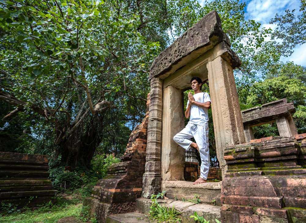 man sitting in concrete gateway