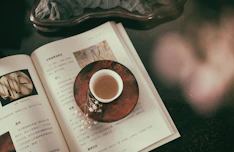 Calm workspace with spiritual resource books and a cup of tea.
