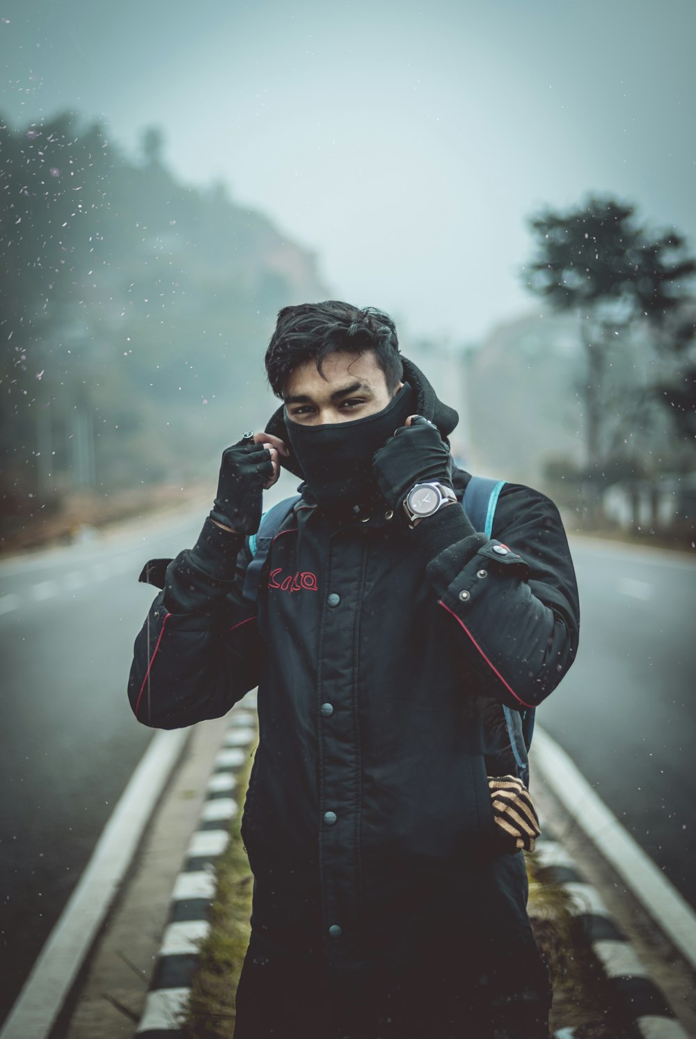 man wearing black hooded jacket