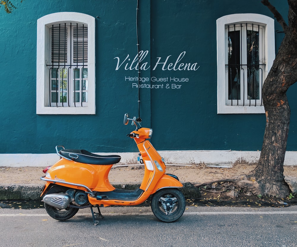 orange motor scooter park near Villa Helena Heritage Guest House building