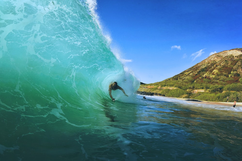 person doing surfboarding during daytime