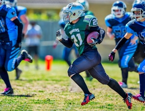 A group of youth football players in action on the field.