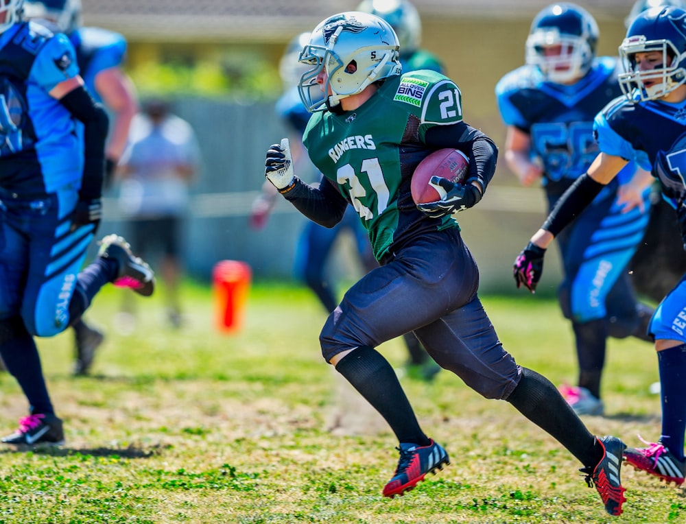 football game on grass field during daytime