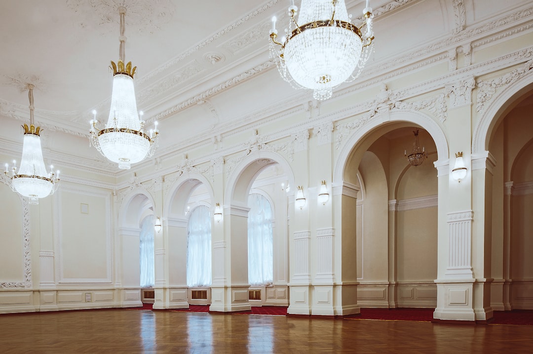 indoor white concrete building with chandelier turned on,