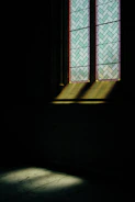 Sunlight shining through a newly created stained glass window with geometric design