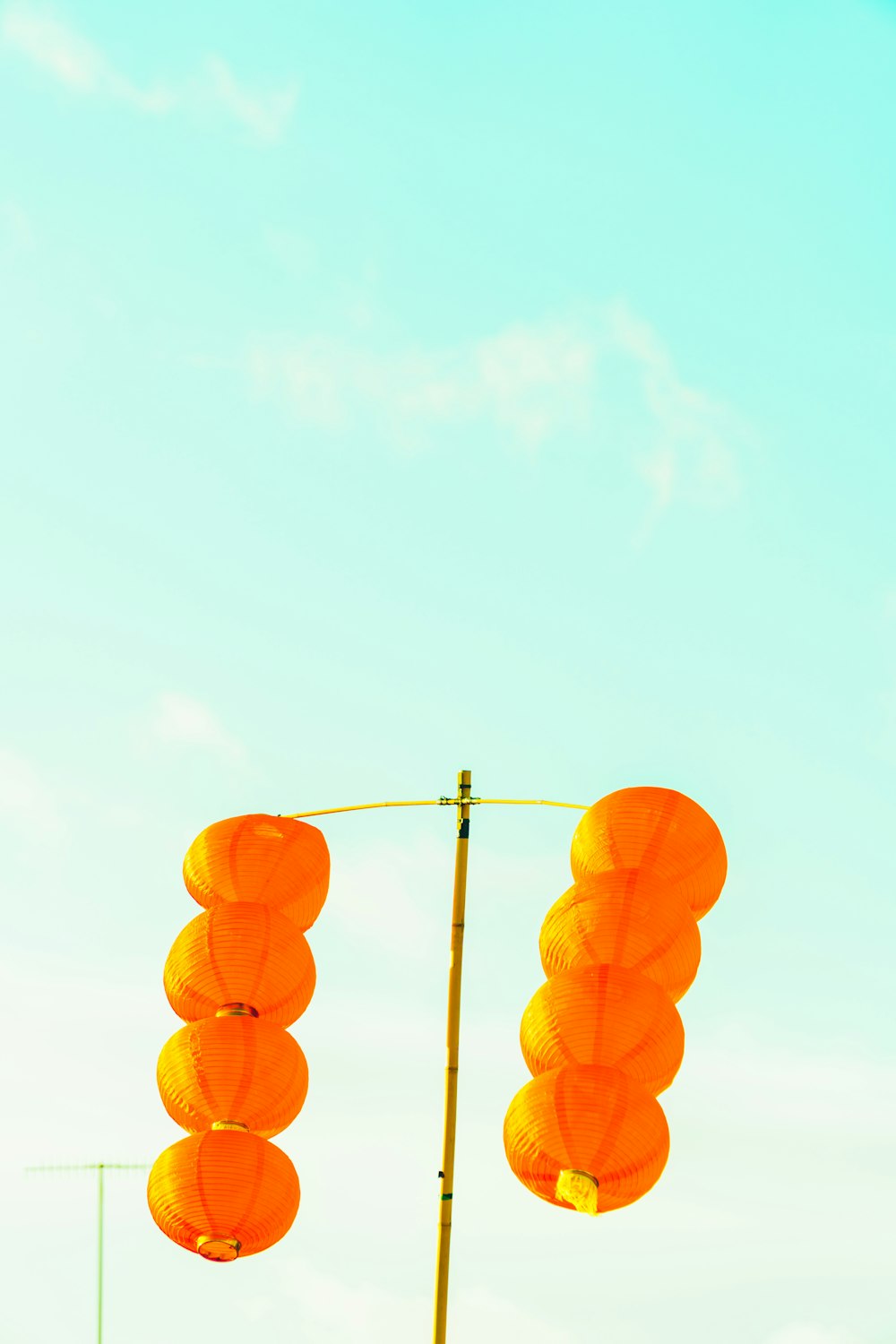 orange hanging lantern under blue sky