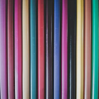 Close-up of a child's hands holding colorful pencils donated by the association.