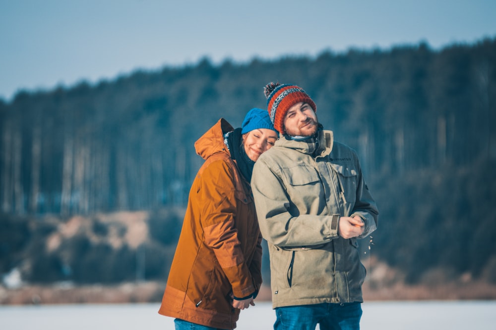 man and woman wearing coat during daytime