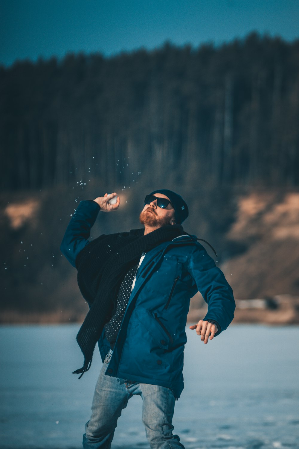 selective focus photography of man throwing snowball