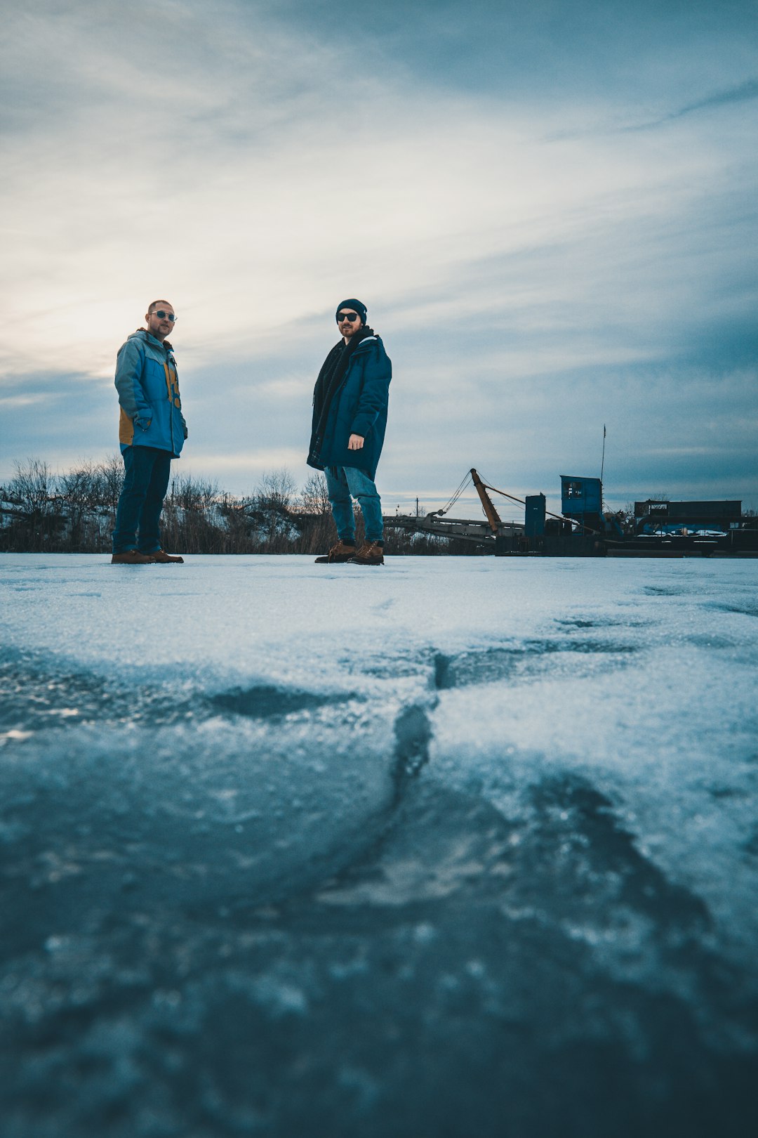 two men standing on snowy ground during daytime