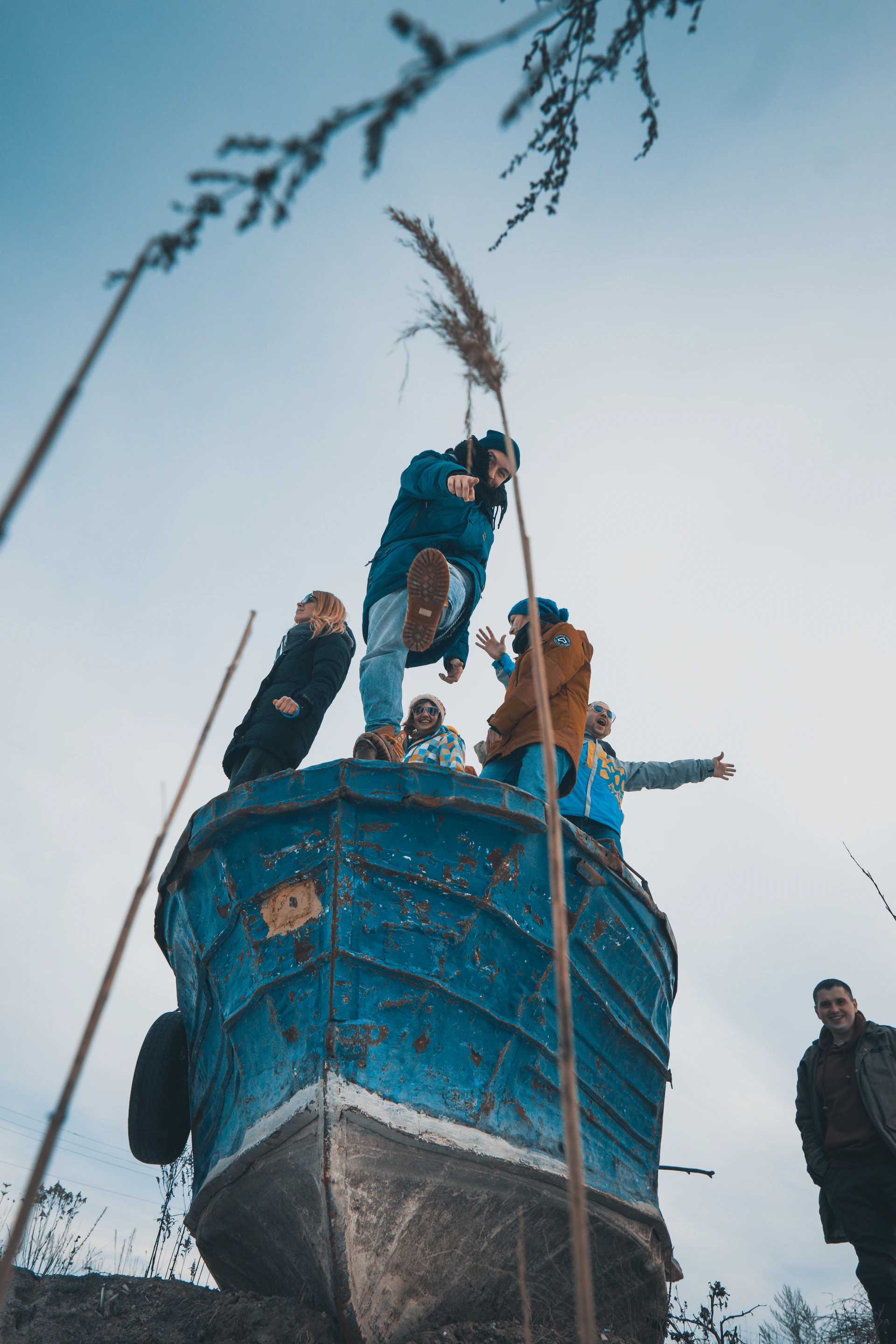 Group of friends laughing together on a boat tour under a bright navy blue sky