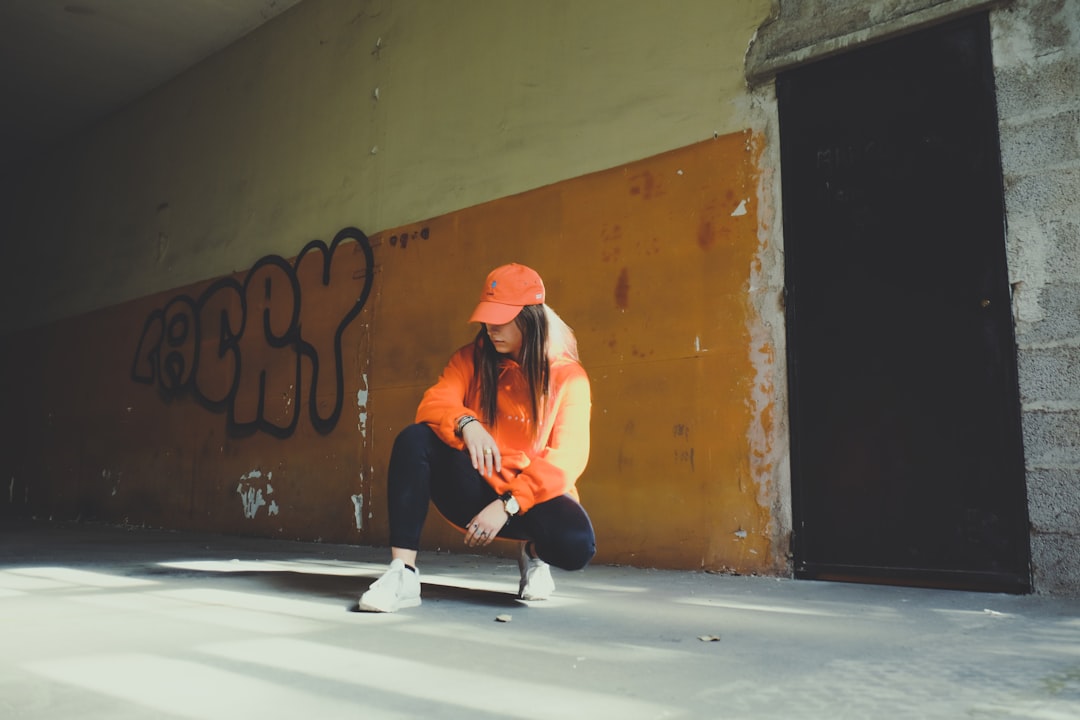 woman wearing orange pullover hoodie