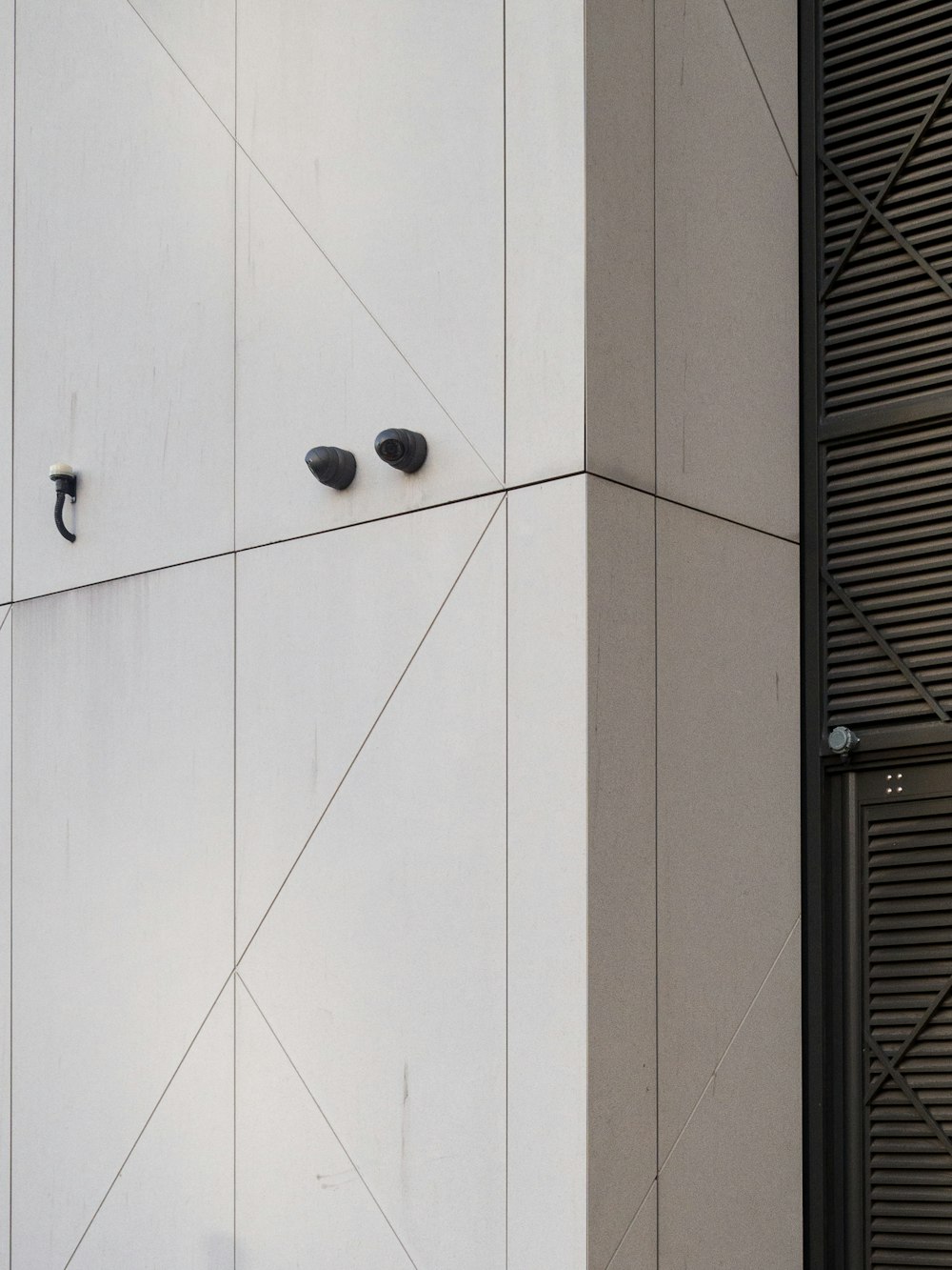 a white building with two black knobs on it