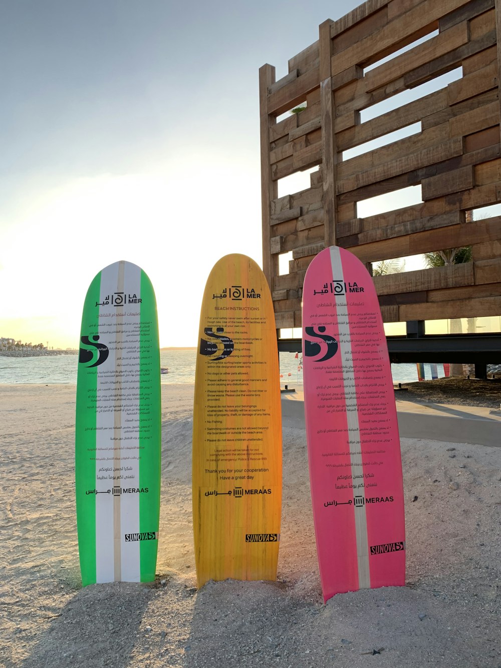 three assorted-color surfboards