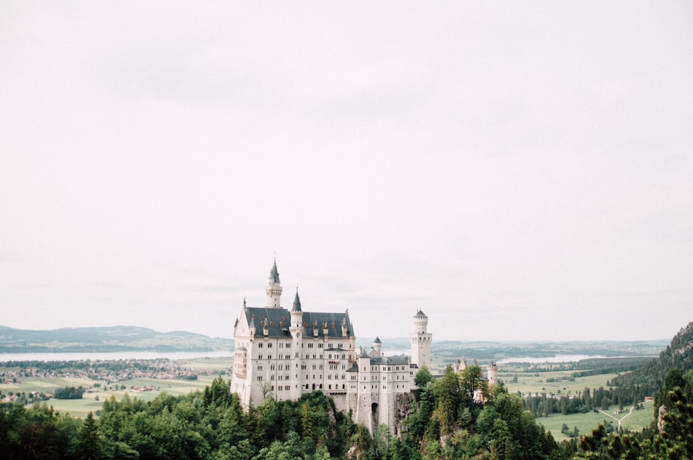 a large castle with towers on top of a hill