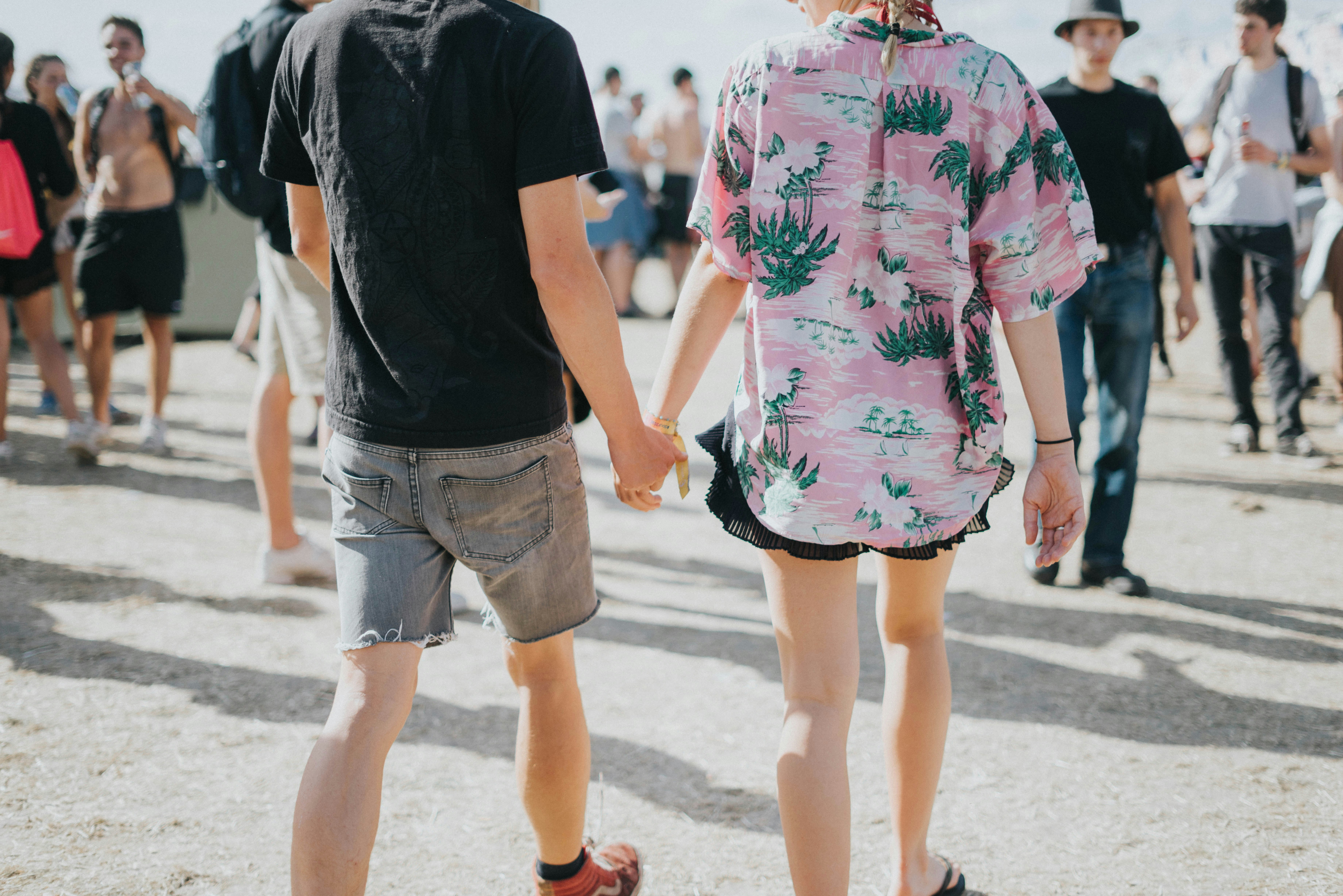 man and woman holding hands at middle of street