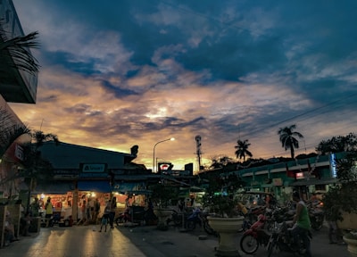 A vibrant street scene capturing candid moments of daily life in warm sunset light.