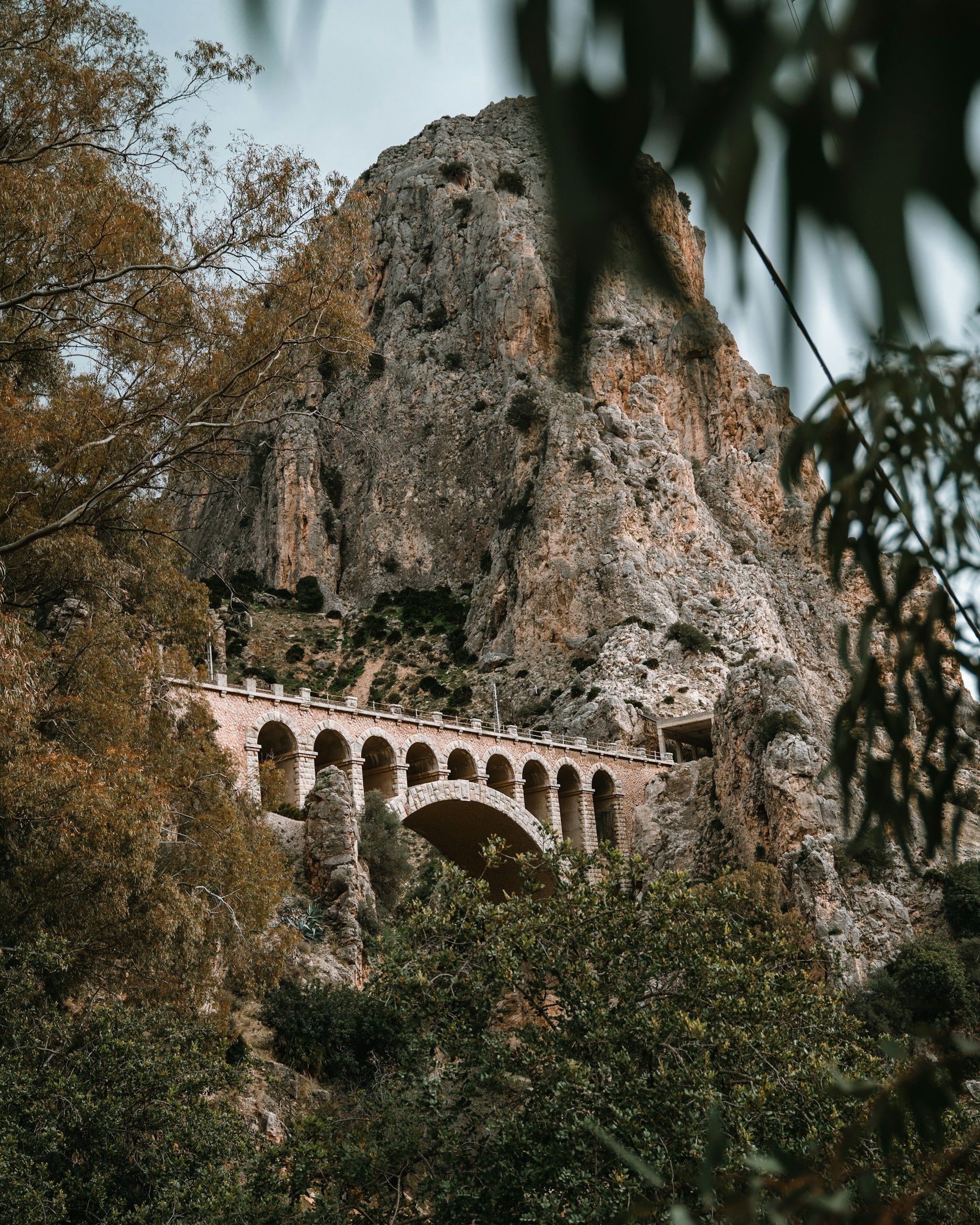 brown concrete bridge near mountain