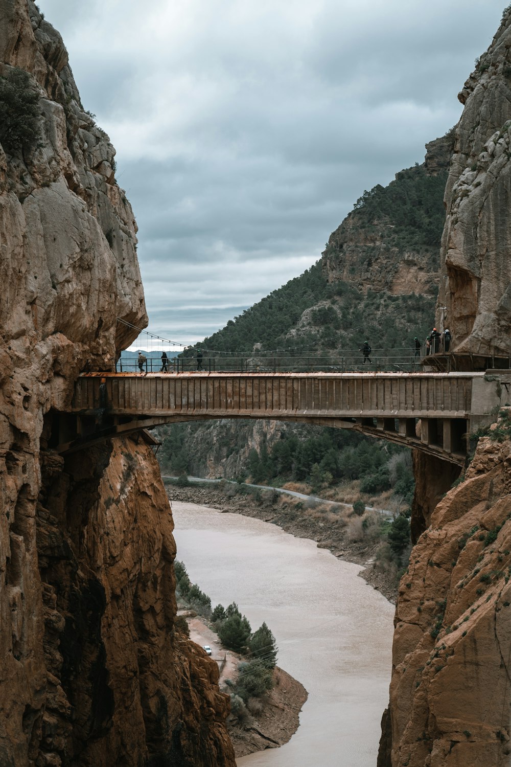 brown bridge between rock formation