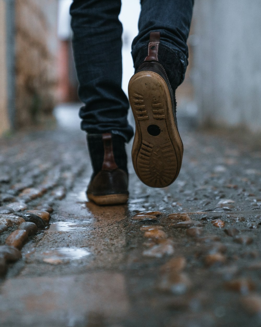close-up photography of person walking on pavement