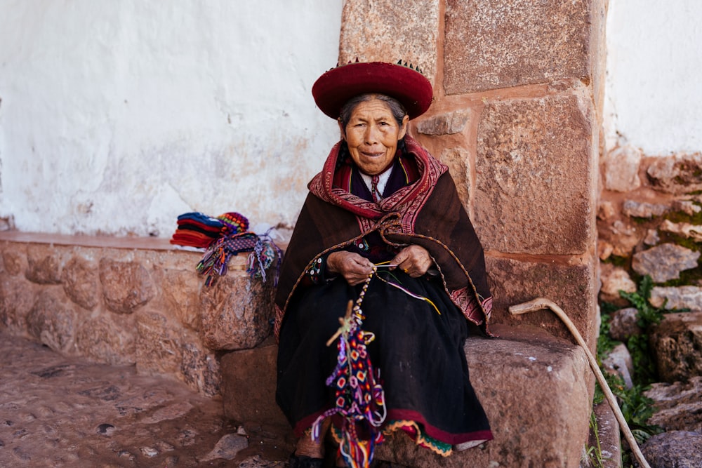 woman sitting on brown rock during daytime