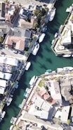 aerial view of houses and boats near body of water