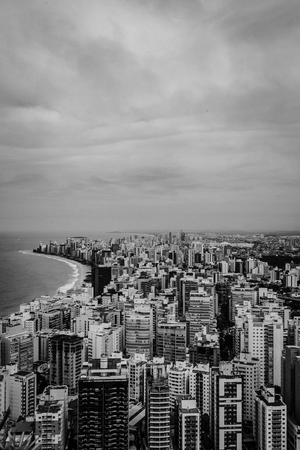 building beside body of water in grayscale photo